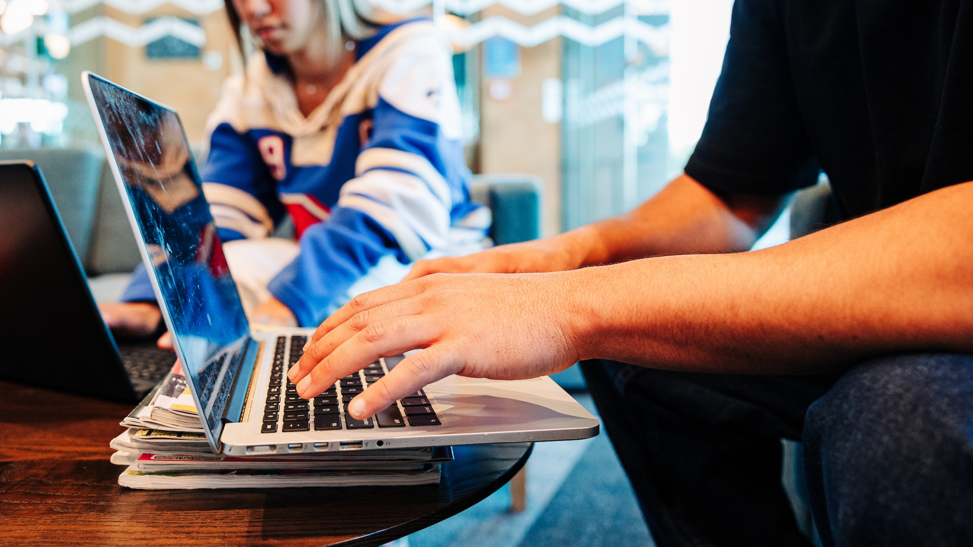 Two students working at their laptops