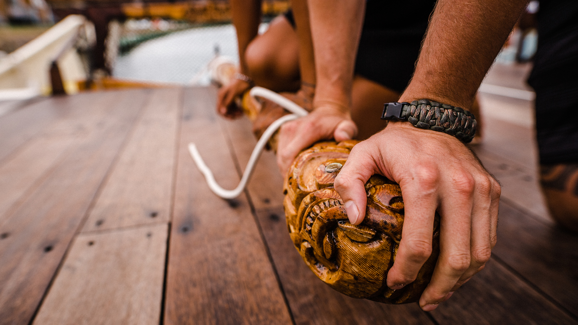 Hands working together onboard a waka